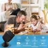 A family playing with building blocks in a living room, with a security camera in the foreground. Produktbild-Vorschau