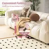 A pink cordless vacuum cleaner is shown in a living room setting, with a sofa and rug in the background. A close-up inset highlights the folding mechanism of the vacuum's tube. Produktbild-Vorschau
