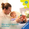 A father and child are reading a book together. Produktbild-Vorschau