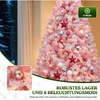 A pink Christmas tree decorated with ornaments and lights, set indoors with a window view of a snowy forest. Produktbild-Vorschau