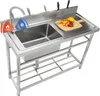 A stainless steel commercial kitchen sink with a faucet and a cutting board with fruit on it. Náhled obrázku produktu