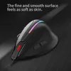 A black ergonomic mouse with RGB lighting is shown on a dark, textured surface with a light streak behind it. Produktbild-Vorschau