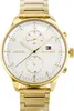 A close-up studio shot of a gold Tommy Hilfiger watch with a white face. Produktbild-Vorschau