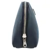 A close-up side view of a dark blue cosmetic bag with a silver zipper. Produktbild-Vorschau