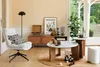 A living room scene with a chair, coffee table, and media console. Produktbild-Vorschau