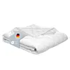A folded white comforter is presented on a white background, with a label attached to it.