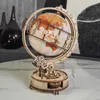 A wooden globe model with intricate gears and a light inside, displayed on a marble surface. Náhľad obrázku produktu