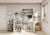 A compact kitchen unit with a refrigerator, sink, microwave, and storage shelves, set in a bright, modern room. Produktbild-Vorschau
