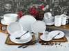 A collection of white ceramic dinnerware, including plates, bowls, and cups, arranged on wooden trays against a chalkboard-style background with decorative red berries. Náhľad obrázku produktu