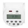 A white digital timer with an LCD screen and buttons. Voir les images du produit
