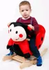 A young child is sitting on a ladybug-themed rocking toy. Náhľad obrázku produktu
