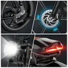 A collage of close-up shots of an electric bicycle, highlighting its features like the rear wheel and brake, disc brake, headlight, and taillight. Voir les images du produit