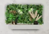 A modular wall panel with artificial plants and decorative items on a shelf. Produktbild-Vorschau