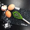 Eggs and a whisk on a cutting board with flour scattered around. Produktbild-Vorschau