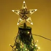 A star-shaped Christmas tree topper with lights, attached to a Christmas tree with more lights. Produktbild-Vorschau