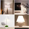 A collage of four different lamp images, showcasing various styles and settings. Produktbild-Vorschau