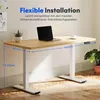 A white electric standing desk with a wooden top, shown in a room with a plant and a laptop. Podgląd zdjęcia produktu