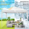A white pop-up gazebo is shown in two different weather conditions: sunny and snowy. The sunny side shows a patio furniture set in a garden, while the snowy side shows the same gazebo with snow falling around it and a winter landscape in the background. Te Voir les images du produit
