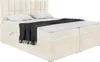 A cream-colored box spring bed with a headboard, mattress, and topper, shown from a diagonal front-side angle. Produktbild-Vorschau
