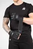 A person wearing a black t-shirt and black shorts, demonstrating the use of black wrist wrap gloves. Produktbild-Vorschau