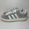 A pair of Adidas Campus 00s sneakers in grey and white are displayed against a white background. Náhled obrázku produktu