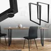 A dining table with black metal legs and chairs, set in a modern dining room. Náhled obrázku produktu