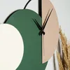 A close-up of a modern wall clock with abstract geometric shapes. Produktbild-Vorschau