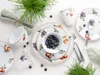 A flat lay of a fruit-themed dinnerware set with blueberries and greenery. Náhľad obrázku produktu