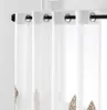 Close-up of white sheer curtains with embroidered leaf patterns hanging on a black curtain rod. Produktbild-Vorschau