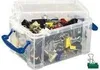 A clear plastic storage box filled with various office supplies like paper clips, binder clips, and other small items. The lid is open, and blue handles are visible on the sides. Náhled obrázku produktu