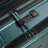 Close-up of a TSA-approved lock and zipper pulls on a teal suitcase. Podgląd zdjęcia produktu