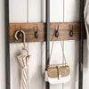 A close-up of a coat rack with an umbrella and a handbag hanging on it. Podgląd zdjęcia produktu