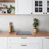 A kitchen countertop with a backsplash and cabinets. Náhľad obrázku produktu