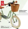 Close-up of a green balance bike with a wicker basket and brown handlebars. Náhled obrázku produktu