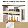 A close-up view of a white and brown narrow kitchen cart with items on its shelves and a towel hanging on the side. Podgląd zdjęcia produktu