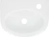 A top-down view of a white ceramic sink basin with two holes. Podgląd zdjęcia produktu