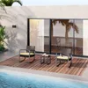 A patio set with two chairs and a small table next to a swimming pool, with a modern building and palm trees in the background. Náhled obrázku produktu