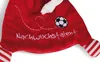 A close-up of a red plush toy with white stitching and a soccer ball. Produktbild-Vorschau