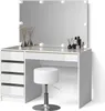 A white vanity table with a large mirror and LED lights, a white stool, and decorative items on the table. Produktbild-Vorschau