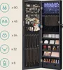 An open jewelry cabinet with interior LED lighting, displaying various jewelry items and makeup. Produktbild-Vorschau