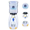 A penguin-shaped water dispenser with a water bottle on top, a glass being filled, and close-up insets of the water bottle label and the penguin's face. Produktbild-Vorschau