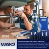 A man is working on plumbing under a sink, with a toolbox and various tools laid out. Produktbild-Vorschau