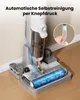 A close-up shot of a wet and dry vacuum cleaner on its charging base, with a diagram showing water flow and a hand pressing a button on the handle. Produktbild-Vorschau