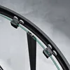 Close-up view of a shower door mechanism with wheels and a glass panel. Produktbild-Vorschau