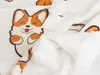 A close-up view of a white blanket with a repeating pattern of cartoon corgis. Anteprima dell’immagine prodotto