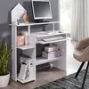A white computer desk with a monitor, keyboard, and various decorative items. Produktbild-Vorschau