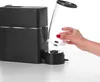 A hand is shown inserting a clear water tank into a black coffee machine. Náhľad obrázku produktu