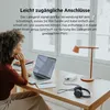 A woman is working at a desk with a laptop, a desk lamp, and a charging station. Náhled obrázku produktu