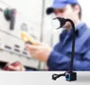 A person in a blue uniform and cap is working with electrical equipment, illuminated by a flexible LED work light. Náhled obrázku produktu