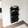 A black shoe cabinet with three flip-down compartments is mounted on a white wall. Náhľad obrázku produktu